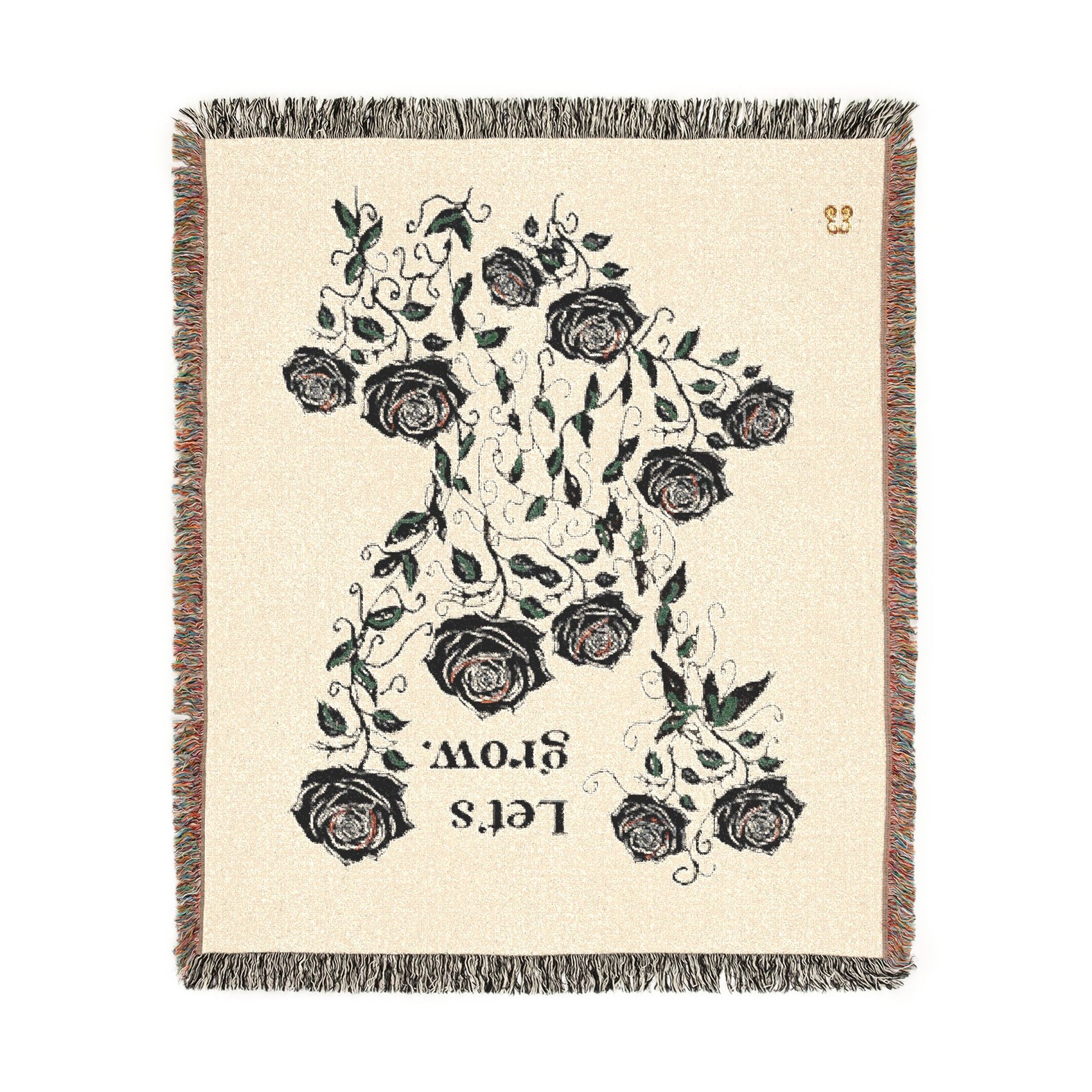 Beige floral throw blanket with tassels, woven cotton blend with black rose and green leaf print