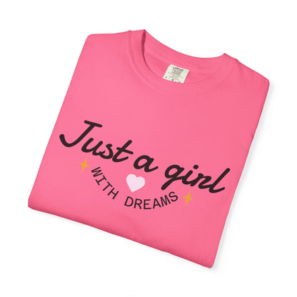 Pink t-shirt with the text 'Just a girl WITH DREAMS' and a small white heart.