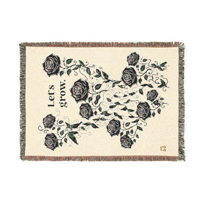 Beige floral throw blanket with tassel fringe, soft woven fabric with rose and leaf pattern