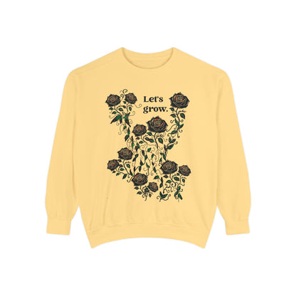 Yellow sweatshirt featuring floral “Let’s grow” rose graphic print