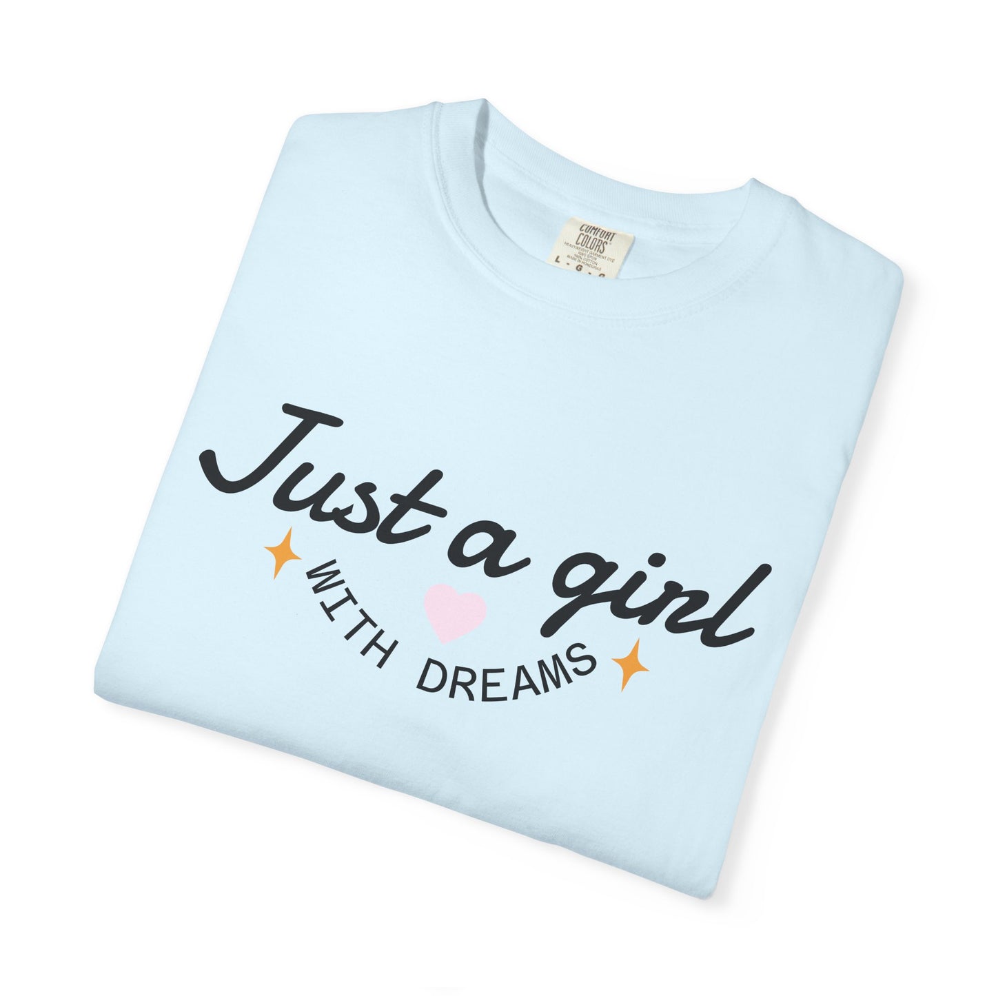 Light blue t-shirt with 'Just a girl WITH DREAMS' text and a pink heart illustration.