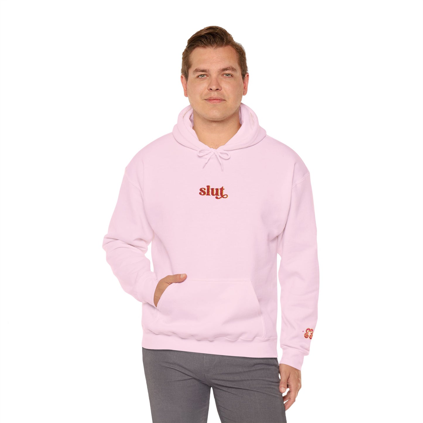 Light pink hoodie with small chest “Slut” script logo and hood drawstrings